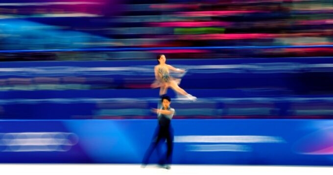 五輪公式Xが公開した、りくりゅうのリフトを流し撮りで捉えたスピード感ある写真